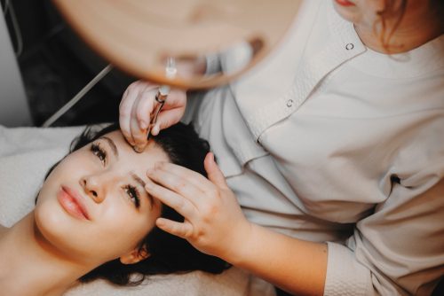 upper view lovely female face leaning on a spa bed with eyes opened doing noninvasive microdermabrasion on her face-img-blog