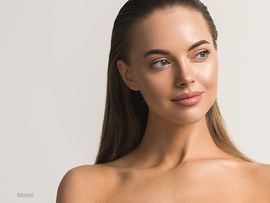Female model with smooth facial features and bare shoulders