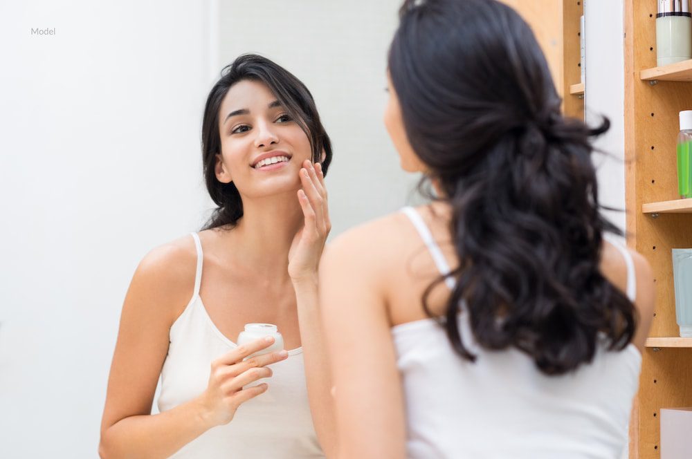 Woman applying skin care products from her medical spa.