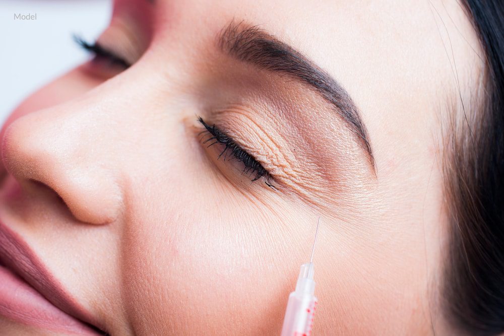 A woman during her BOTOX® Cosmetic treatment to treat crow's feet.