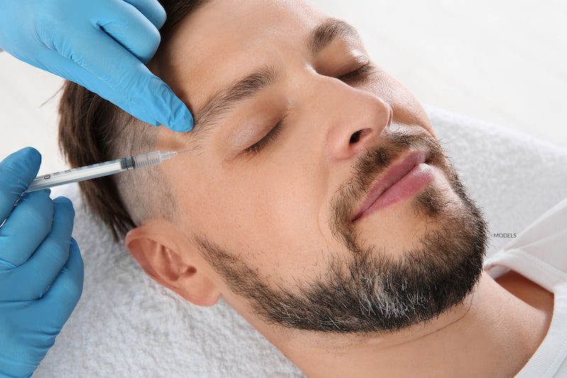 Man receiving a cosmetic injection.