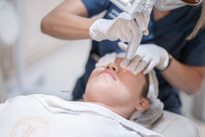 Female patient undergoing laser therapy on her face