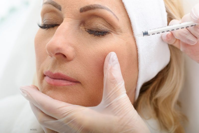 Middle-aged woman having a BOTOX® Cosmetic injection in her upper face