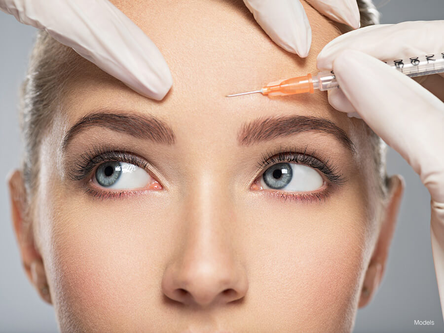 Close up of woman receiving an cosmetic injectable to the forehead
